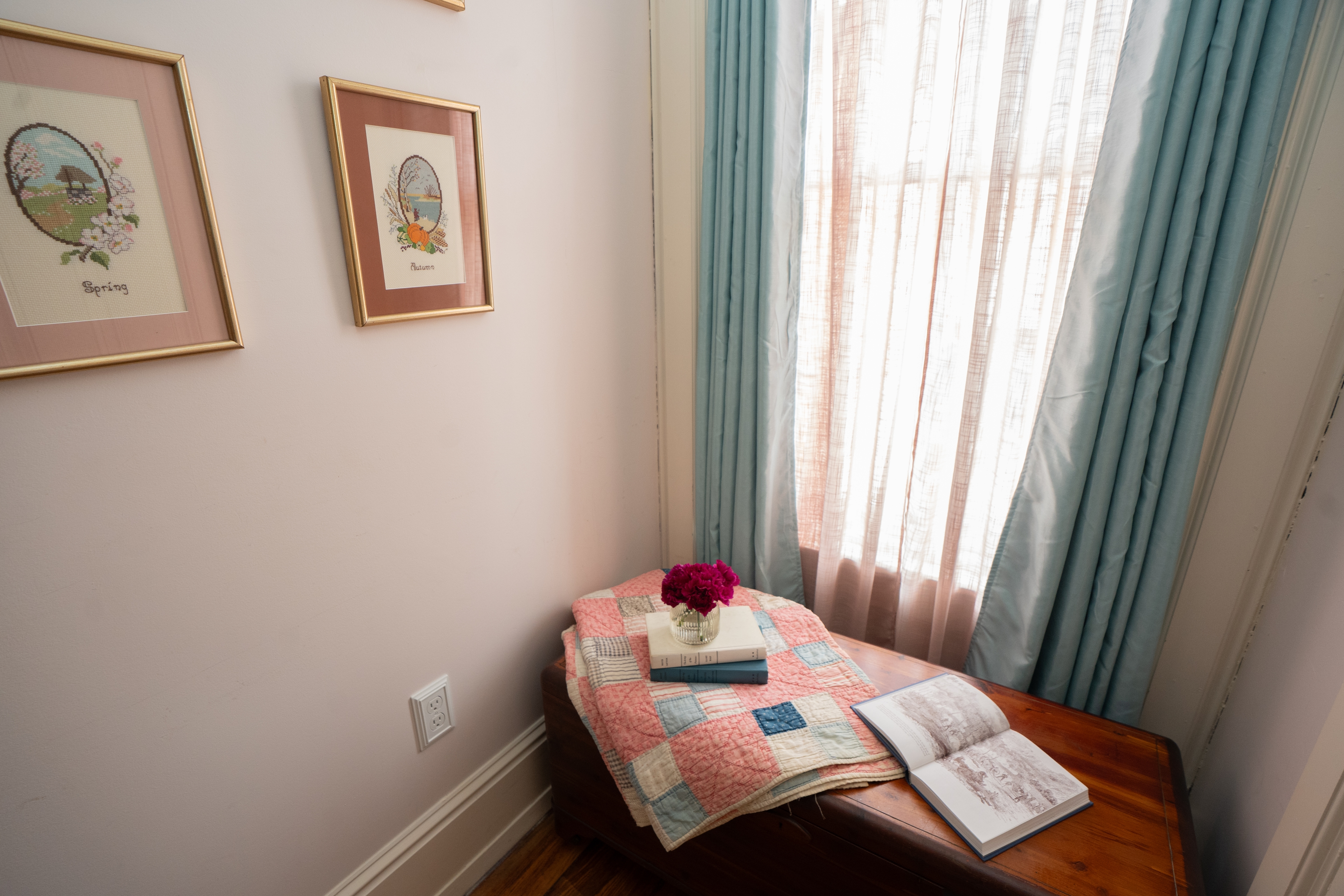 Cozy nook in the Elizabeth Room with a vintage trunk, depicting space to sit and read or enjoy coffee