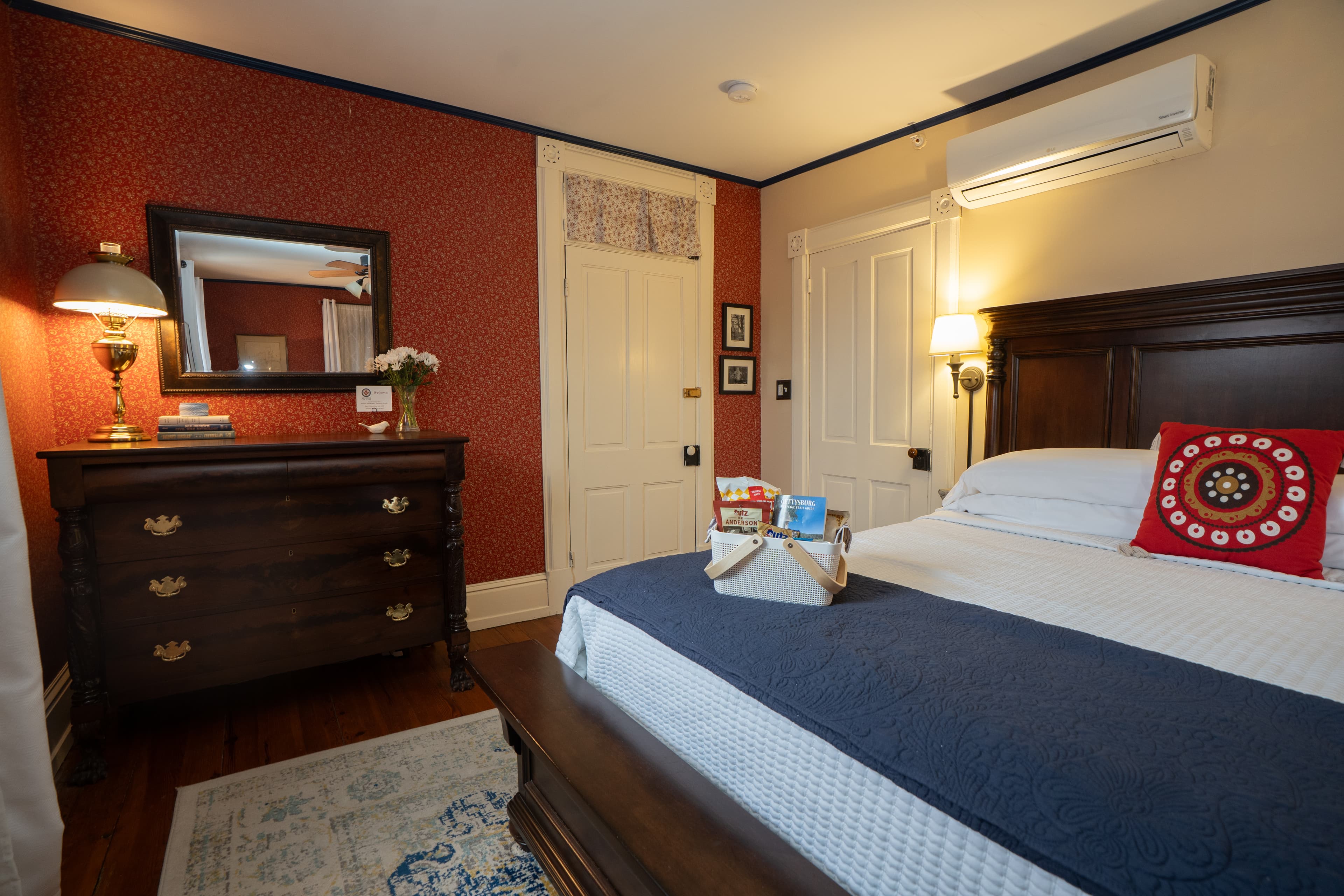 A wide angle photo of the Motter Room en-suite bathroom with double vanity and walk-in shower