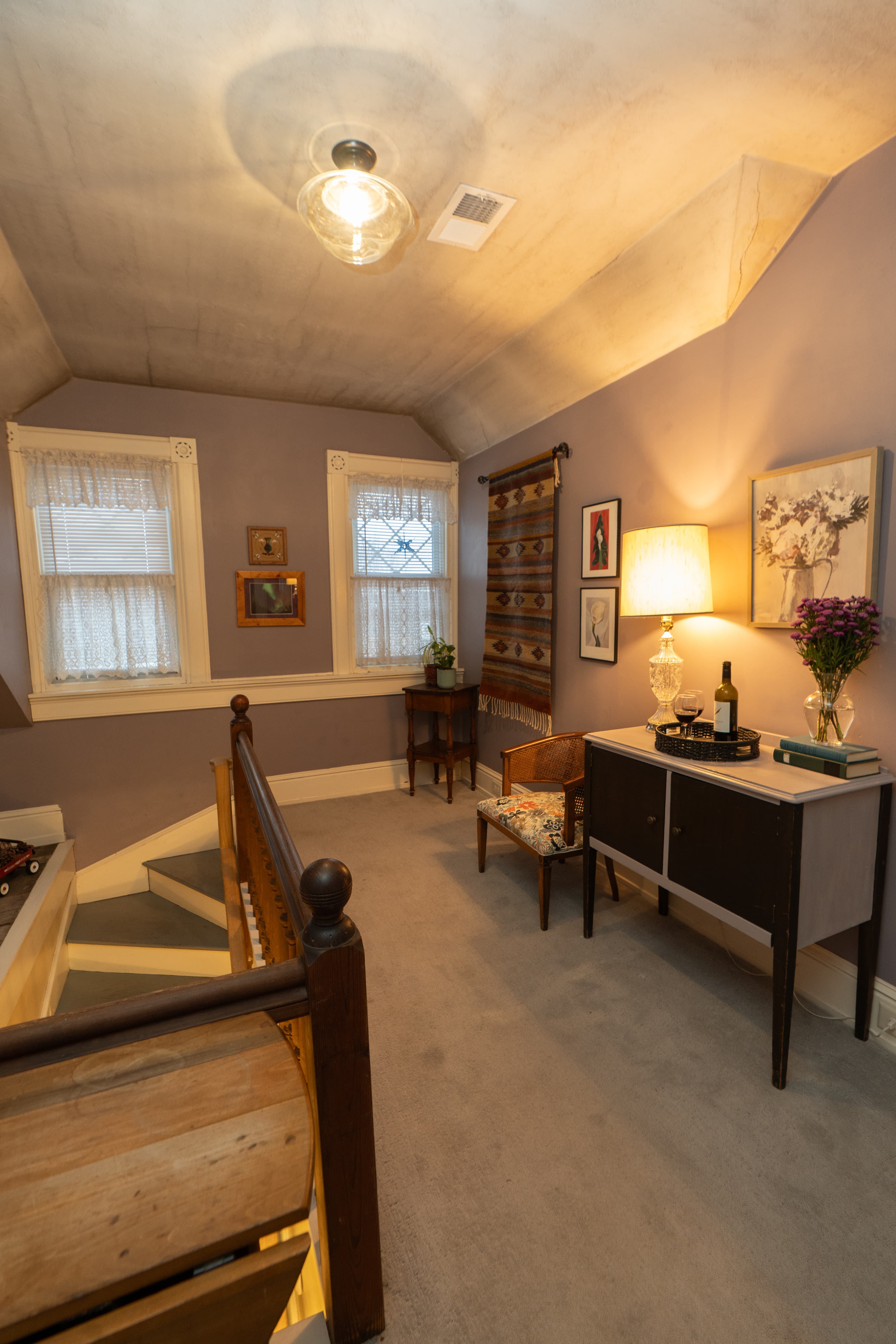 Landing outside the Parsons Room with cabinet, artwork and seating