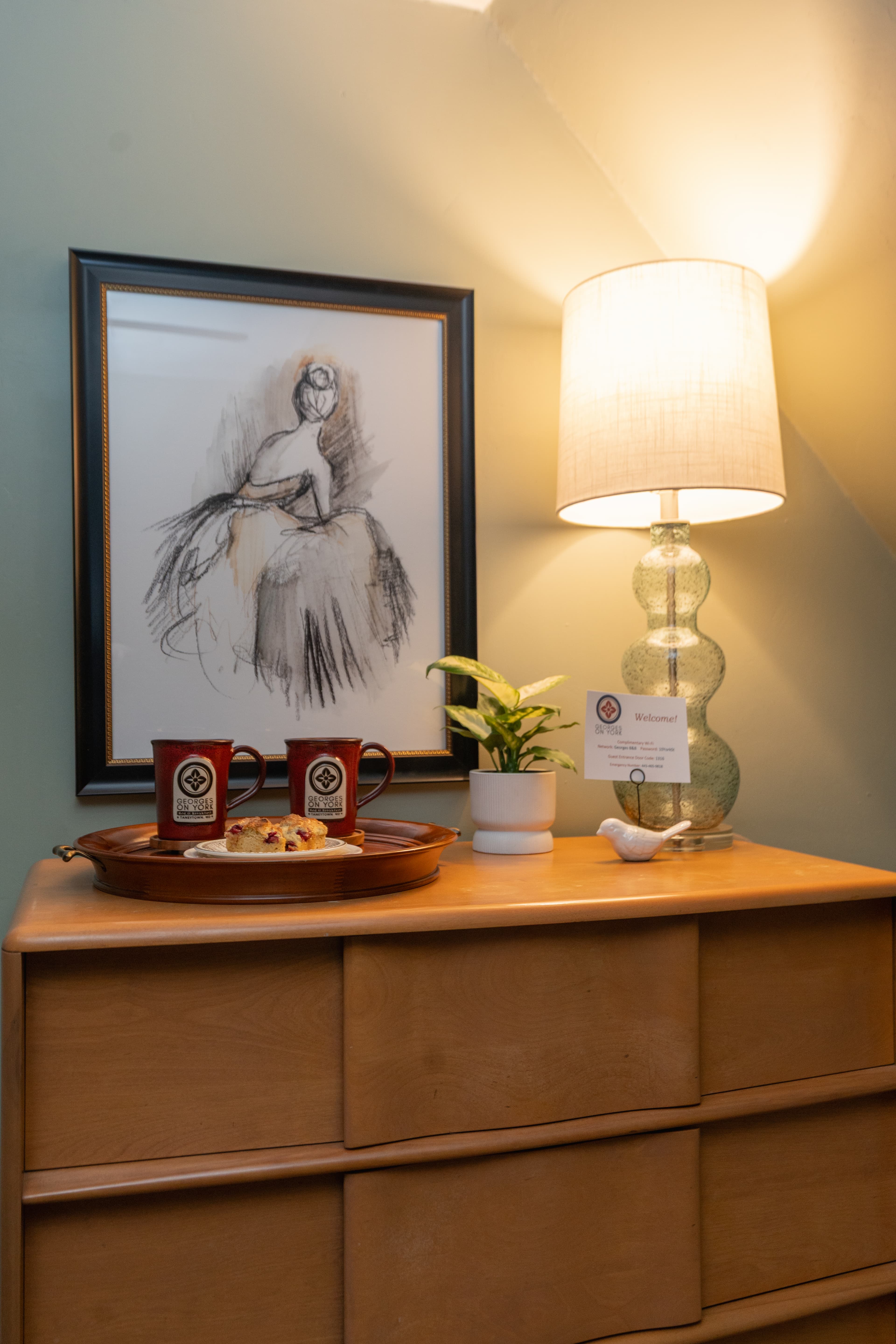 Dresser in the Parsons Room with lamp and painting over it