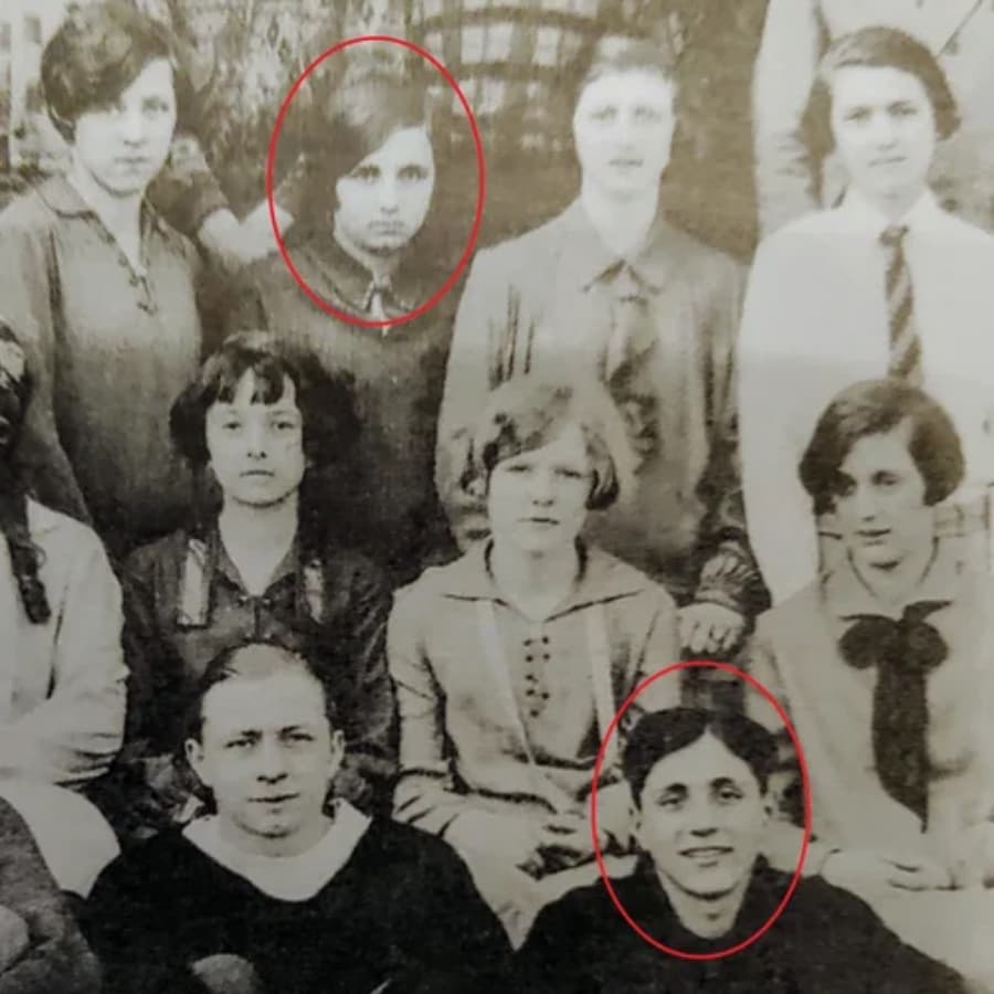 A historical black-and-white photo featuring a group of young women and girls, with two individuals circled.