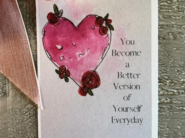 a card with a pink heart and red roses and a romantic saying