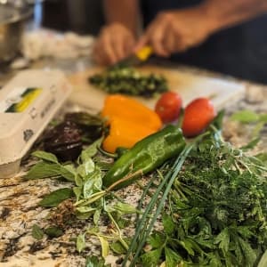 fresh vegetables on a table being prepped for a meal