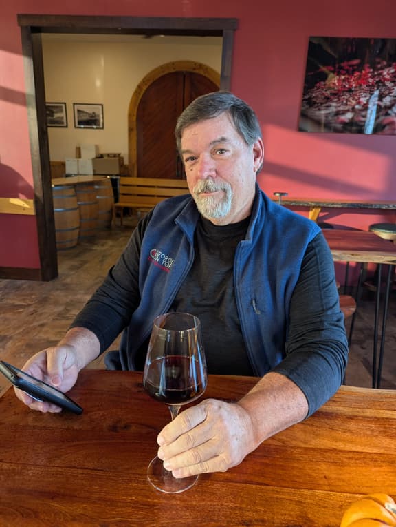 Innkeeper Chris with wine glass at a winery